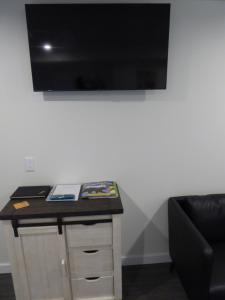 a room with a desk with a television on a wall at Bear Rock Inn in Jasper