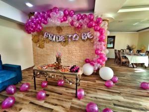 um arco de balão numa sala com balões cor-de-rosa e brancos em Vila Breza em Laktasi