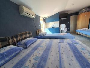 a room with two beds and a air conditioner at Apartments Milka in Dobra Voda