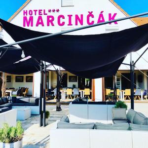a hotel margarita tent with couches in front of a building at Hotel Marcincak*** in Mikulov