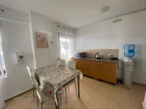 a kitchen with a table and a table and a table and chairs at Pension El Parque in Calpe