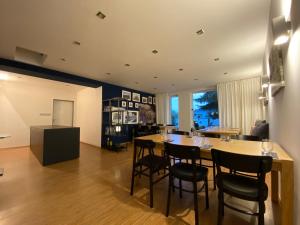 a dining room and living room with a table and chairs at Villa Green in Sliač