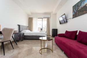 a living room with a couch and a bed at Skyroof SKG in Thessaloniki