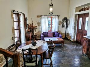 a living room with a table and a purple couch at Villa Filiza in Sívas