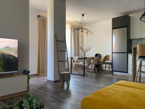 a bedroom with a table and a dining room at Teddy Hills apartment in Velingrad