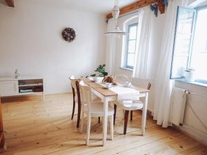 a dining room with a white table and chairs at Chaloupka Pálava in Pavlov