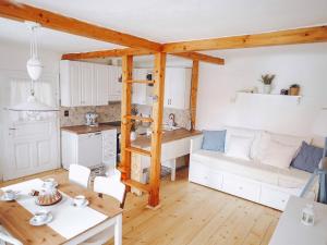 a kitchen and living room with a couch and a table at Chaloupka Pálava in Pavlov