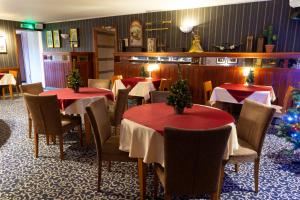 a restaurant with tables and chairs with christmas trees on them at Tähetorni Hotel in Tallinn