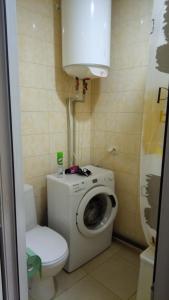 a bathroom with a washing machine and a toilet at Excellent Studio Apartaments in a Secure Residential Complex Comfort Town КТ-01 in Kyiv