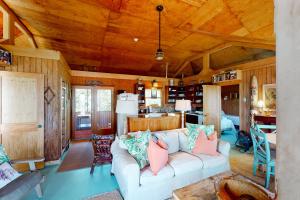 a living room with a white couch and wooden ceilings at Sho-rest in Folly Beach