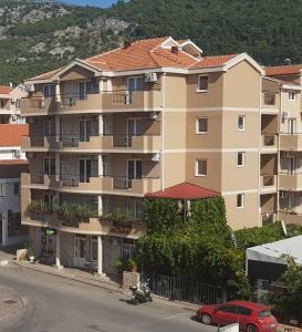 a large apartment building on the side of a street at Villa Pedja Zec Exclusive 3+ in Budva