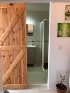 a wooden sliding door in a bathroom with a shower at Casa do Correio in Odeleite +18 photos