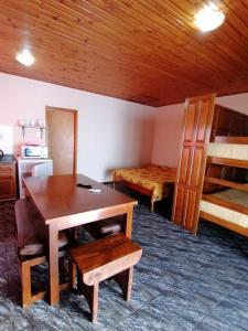 a room with a desk and a bedroom with bunk beds at POSADA SANTA CECILIA in Termas del Daymán