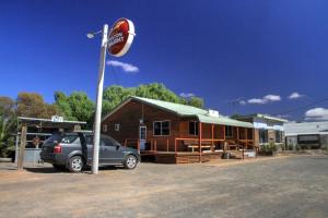 a car parked in a parking lot in front of a building at Ivanhoe Hotel Motel in Ivanhoe +2 photos