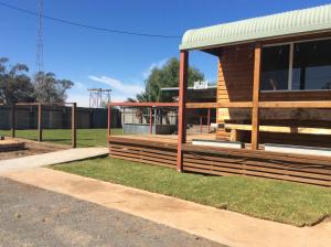 a wooden building with a field in the background at Ivanhoe Hotel Motel in Ivanhoe