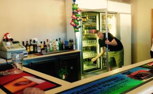 a man standing in front of a refrigerator at Ivanhoe Hotel Motel in Ivanhoe