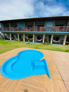 a blue floor in front of a building at Pousada Manga Azul in Barra de Camaratuba