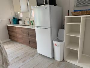 a kitchen with a white refrigerator and a sink at Tides Inn on the Bay Vacation Homes in Bradenton Beach