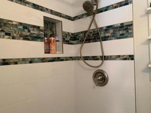y baño con ducha con cabezal de ducha. en Tides Inn on the Bay Vacation Homes en Bradenton Beach