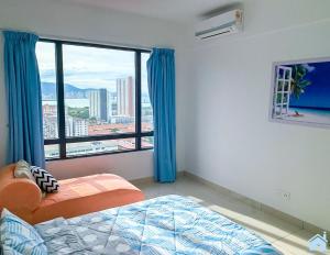 a bedroom with a bed and a large window at HomeSweetHome in Perai
