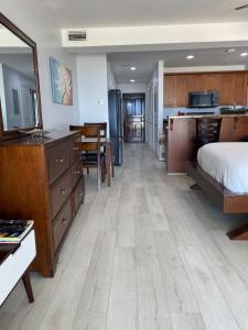 a bedroom with a bed and a kitchen with a desk at La Vista Azul Resort - Studio in Turtle Cove