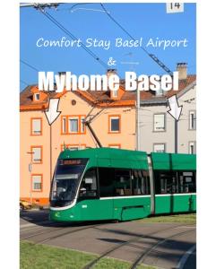 a green bus is driving down a street at Comfort Stay Basel Airport 3B46 in Saint-Louis