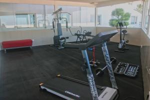 a gym with a treadmill and several exercise bikes at Choice City Hotel in Surabaya