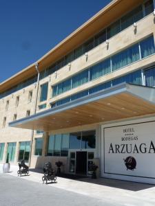 a large building with a sign in front of it at Hotel & Spa Arzuaga in Quintanilla de Onésimo