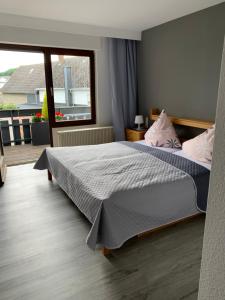 a bedroom with a large bed and a window at vina am ring in Mannebach