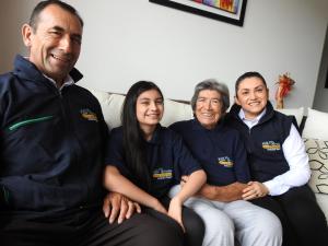 a group of three people sitting on a couch at Posada Rural Villa Rouse in Guachantivá