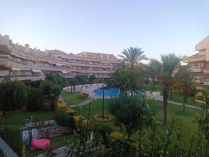 a view of a resort with a pool and palm trees at Apartaments Marítim Torre Valentina in Sant Antoni de Calonge