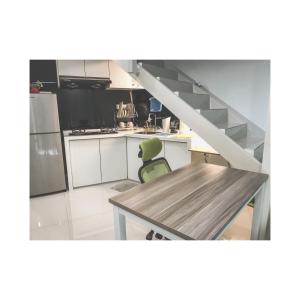 a kitchen with a dining table and a staircase at The ceo suites by Zenbnb in Bayan Lepas