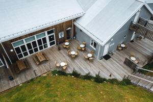 an overhead view of a deck with tables and chairs at Blabjorg Resort in Borgarfjordur Eystri