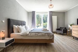 a bedroom with a bed and a chair and a window at stuub langenbach in Titisee-Neustadt