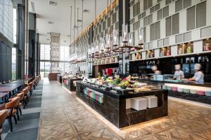a restaurant with a buffet line with people in the background at Villa Fontaine Grand Tokyo Ariake in Tokyo