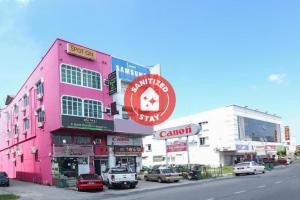 a pink building on the side of a street at SPOT ON 89796 D'noor Budget Inn in Kota Bharu