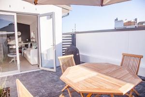 a patio with a table and chairs and a room at Pelicans View in Yzerfontein