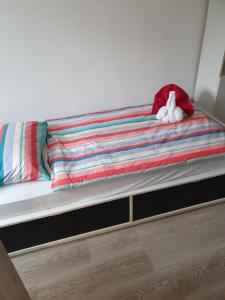 a bed with a stuffed animal on top of it at Apartma Alja in Kranjska Gora