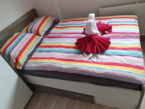 a bed with two stuffed animals on top of it at Apartma Alja in Kranjska Gora