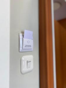 a white box on the door of a room at Privato Suite in Kembaran