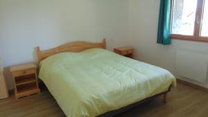a bedroom with a bed and two night stands at Appartement 52m2 - Location vacances Vosges in Belmont-sur-Buttant