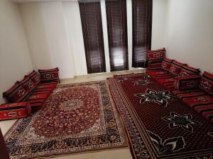 a room with two red chairs and a rug at Royal Sea View Villa with Private Pool in Ras al Khaimah