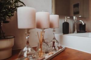 a table with two candlesticks and three candles on it at Tiny House Lebenshofalpakas in Ziemetshausen