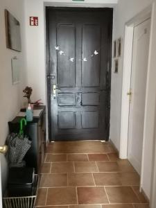 a hallway with a black door with butterflies on it at Vila Julija in Bled