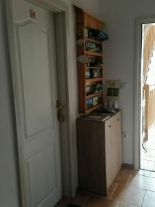 a small kitchen with a stove and a door at Vila Julija in Bled