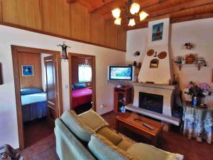 a living room with a couch and a fireplace at Casa Atalaya in Corme-Puerto