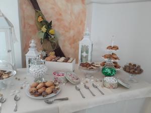 a table with plates of food and desserts on it at Hotel Resort Nuraghe Arvu in Cala Gonone