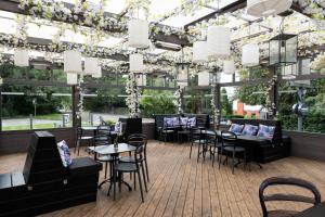 a restaurant with tables and chairs and lights at The Merlin by Innkeeper's Collection in Alderley Edge