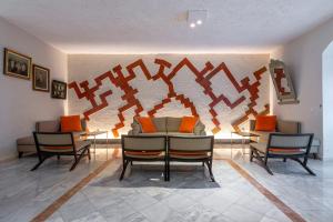a room with chairs and a table and a wall at Skala Hotel in Skala