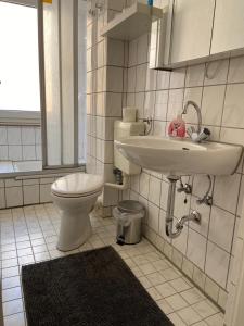 a bathroom with a toilet and a sink at City Studio 2 in Bremerhaven